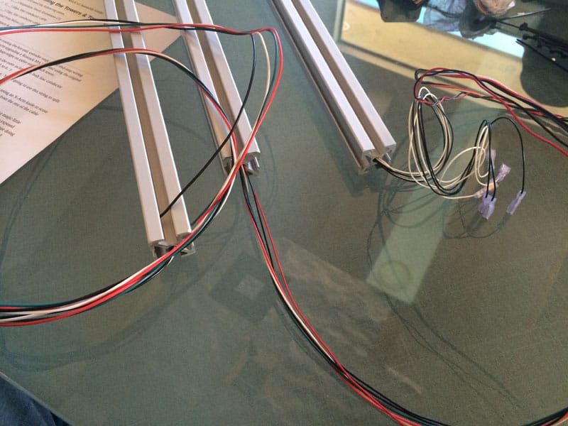 Tangled wires on glass table in machining context.