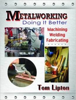 A person welding in a workshop.