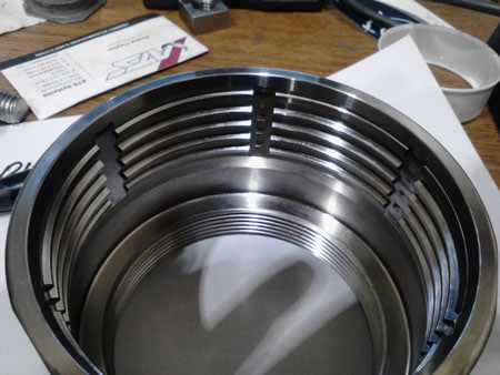 Monel socket broach with parallel grooves on a white surface.