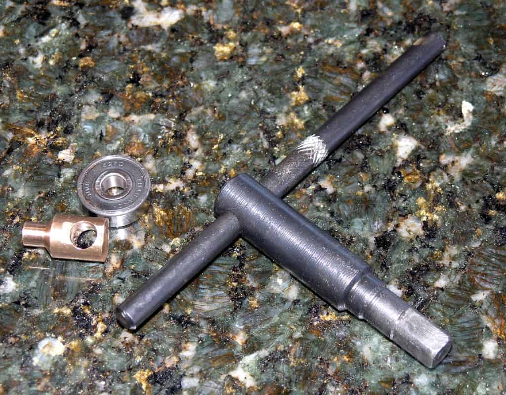 Tools on dark green granite surface