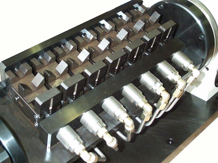 Black metal device with silver screws and rectangular blocks.