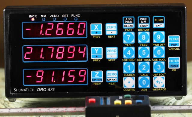 Digital display panel with blue and red text on a black background.