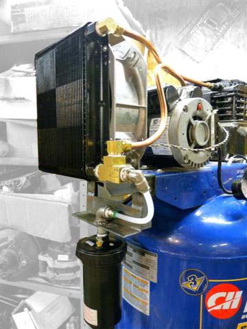 Blue air compressor with aftercooler and black cylindrical tank.