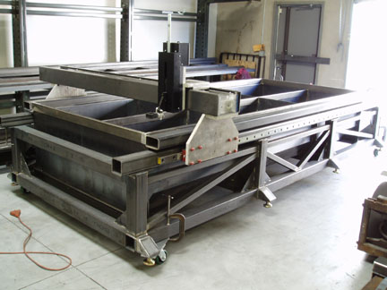 Sturdy metal frame with thick metal plates and four casters on the bottom.