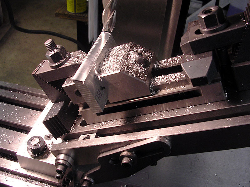 A milling or lathe machine with a dovetail cut setup.