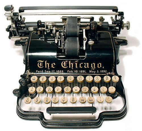 Vintage manual typewriter with 'The Chicago' logo and black and white keys.