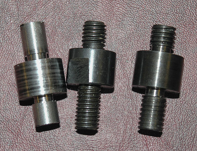 Metal threaded cylindrical pieces.