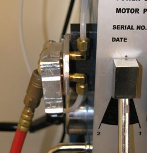 Silver metal object with black text "MOTOR P" and "SERIAL NO." in bold font.