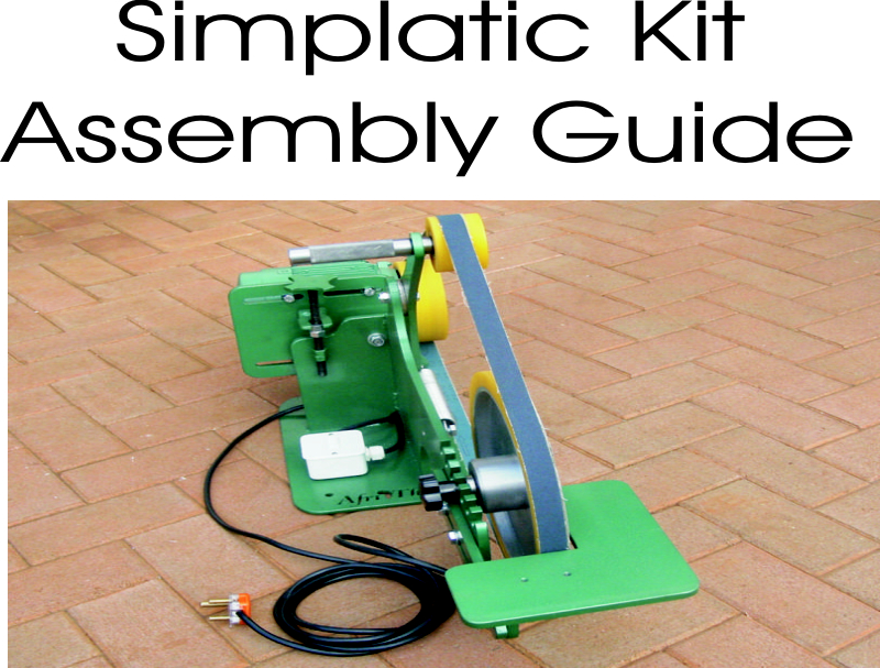 Green metal device with yellow wheels and black cord on red brick floor.