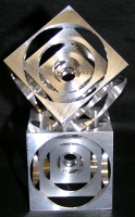 Stacked cubes with circular holes and angled positioning.