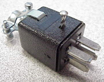 Small black electrical component with two metal prongs and a screw.