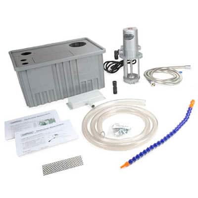 Gray plastic container, clear tube, orange/blue hose, black cord, metal object, instruction sheet, and gray/white checkered object.