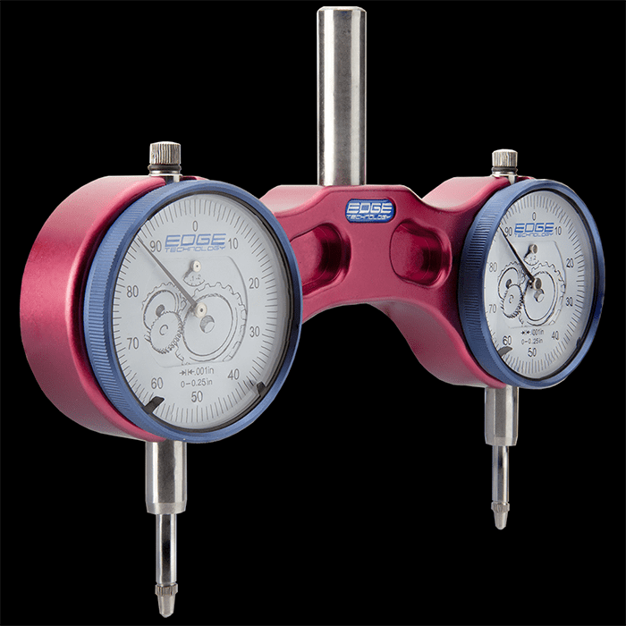 Dual-dial dial indicator with precision measuring functionality in a machine shop setting.