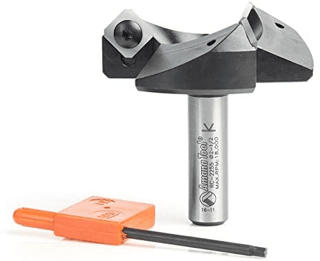 Metal router bit with black shaft and silver top, accompanied by an orange tool.