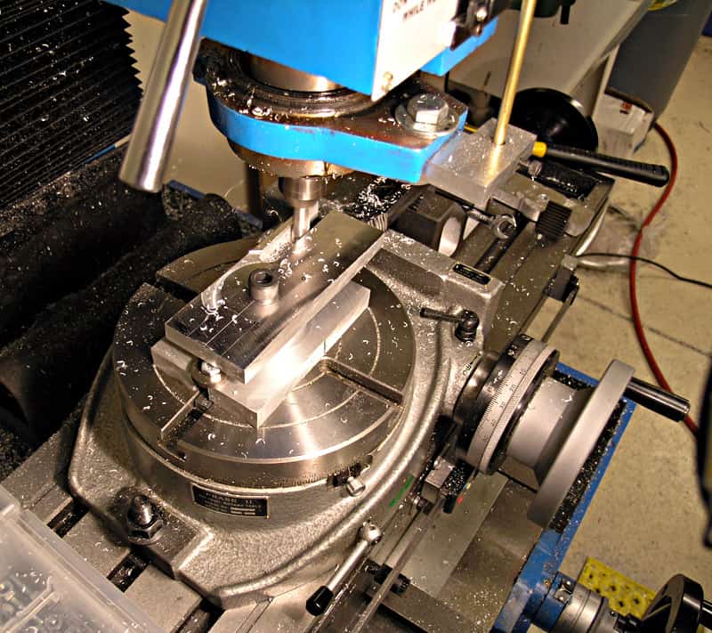 Metalworking machine in a workshop setting on a gray background.