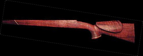 Wooden rifle stock with reddish-brown finish.