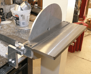 Silver metal object on workbench in machine shop setup