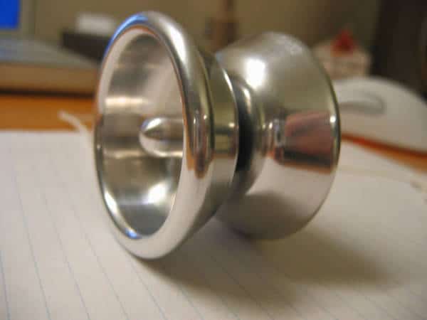 Silver aluminum object with concave center and smooth surface.
