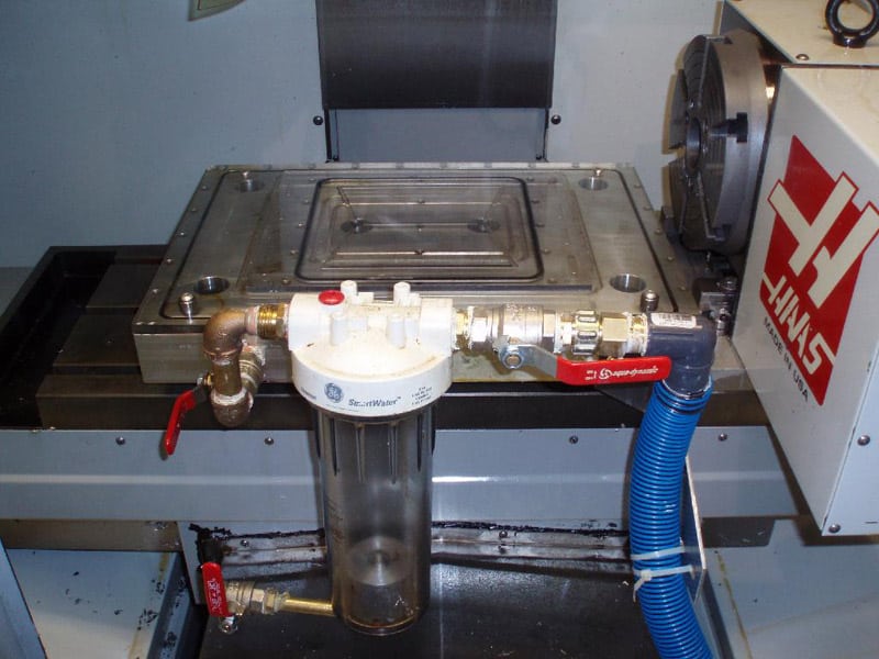 Large metal machine with CNCCookbook logo and attached pipes.